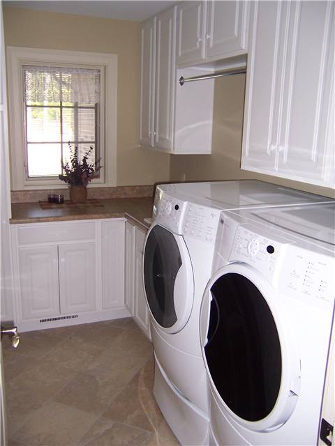 Painted cabinets - Laminate countertop - Clothes rod